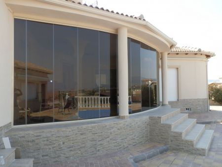Campos Del Rio- Curved Terrace. Tinted Glass