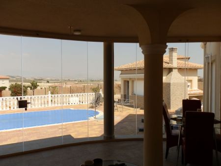 Campos Del Rio- Curved Terrace. Tinted Glass